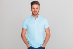portrait of relaxed young man wearing light blue polo t-shirt