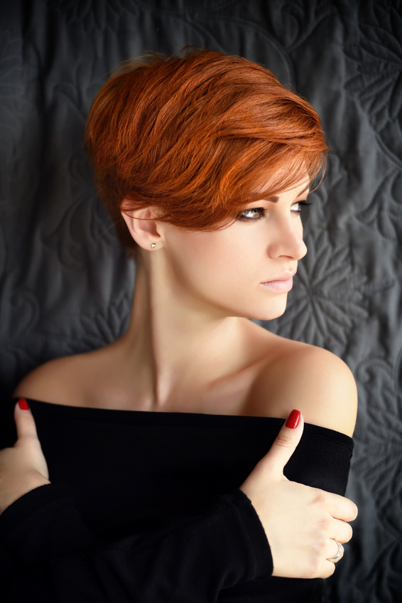 Portrait of a beautiful young red-haired woman with short hair